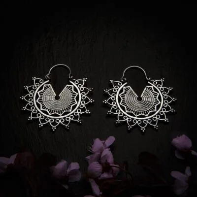 KIWA jewellery brand product image of a pair of silver plated earrings called Emilia, set on a dark granite background with dark pink coloured flower decoration on the lower end.