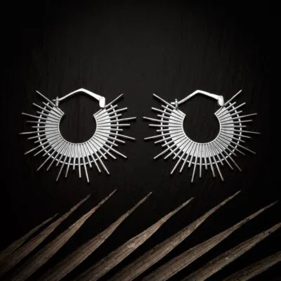 KIWA jewellery brand product image of a pair of silver plated earrings called Ida, set on a dark granite background with light coloured leaf decoration on the lower end.