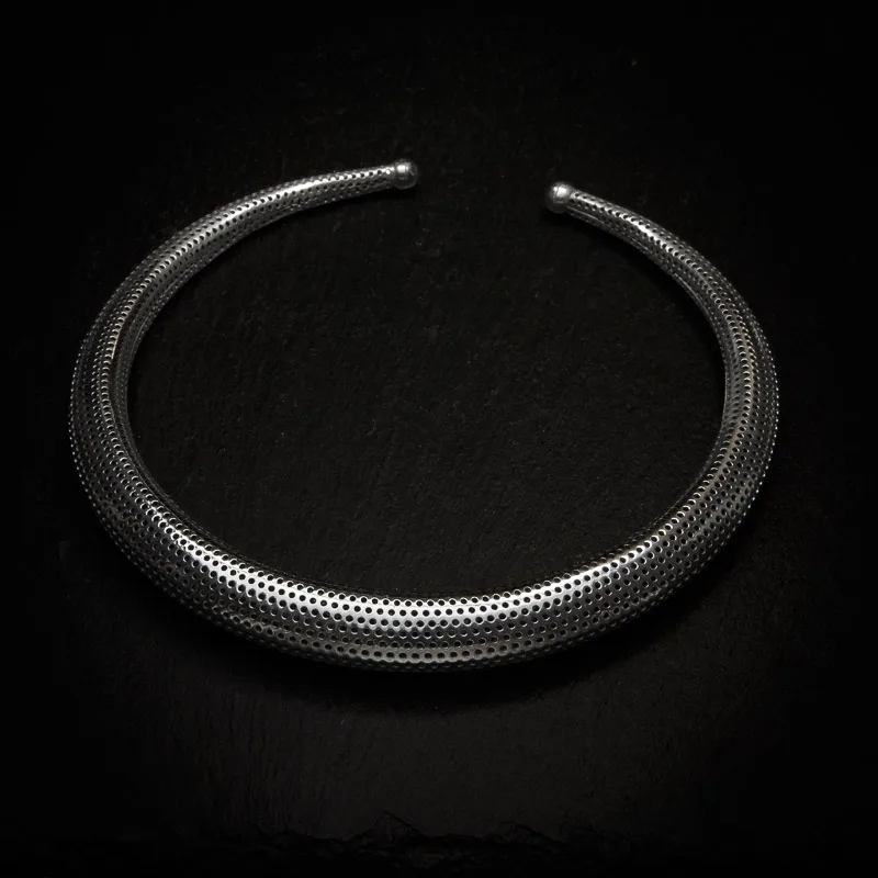 KIWA jewellery brand product image of a single silver plated necklace called the Inspiration choker, set on a dark granite background with no decoration