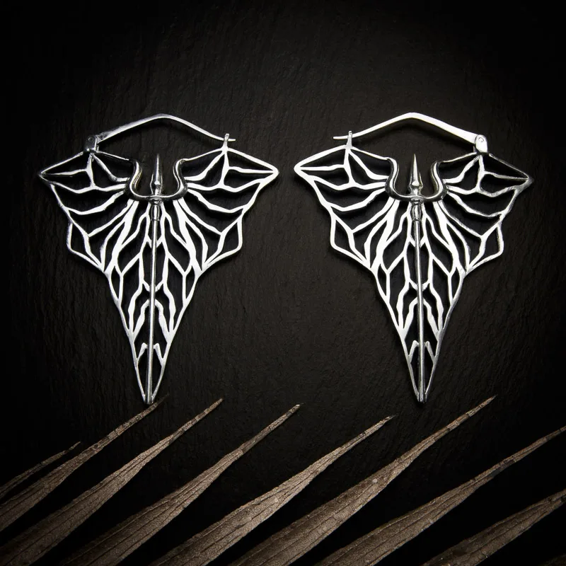 KIWA jewellery brand product image of a pair of silver plated earrings called Kali set on a dark granite background with light coloured leaf decoration on the lower end.