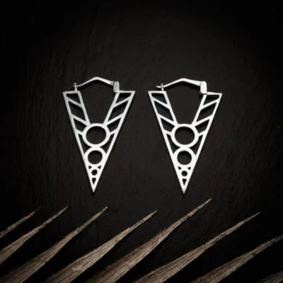 KIWA jewellery brand product image of a pair of silver plated earrings called Kentaura set on a dark granite background with light coloured leaf decoration on the lower end.