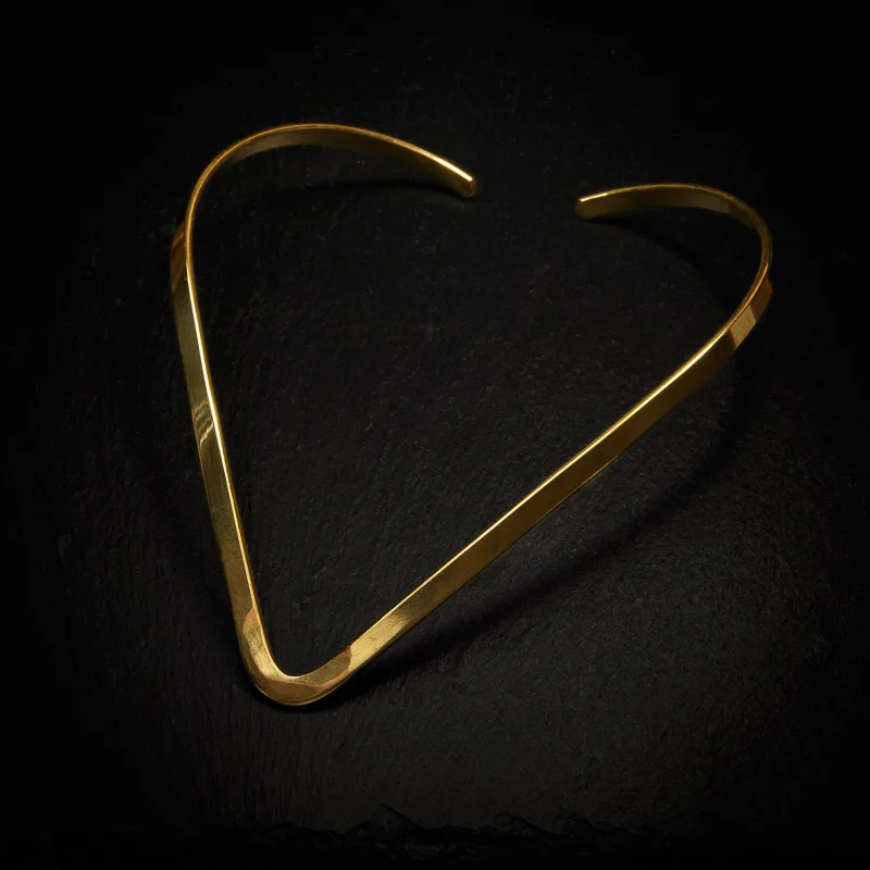 KIWA jewellery brand product image of a single brass necklace called the Nera choker, set on a dark granite background with no decoration