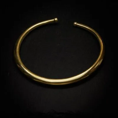 KIWA jewellery brand product image of a single brass necklace called the plain choker, set on a dark granite background with no decoration