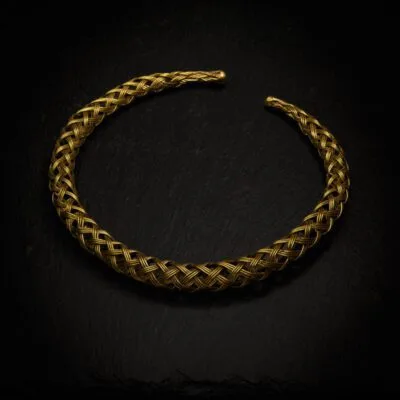 KIWA jewellery brand product image of a single brass necklace called the plait choker, set on a dark granite background with no decoration