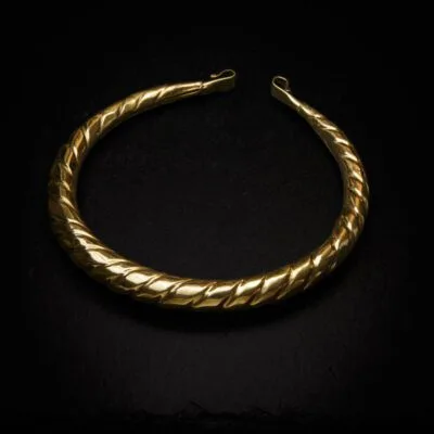 KIWA jewellery brand product image of a single brass necklace called Teuta choker, set on a dark granite background with no decoration