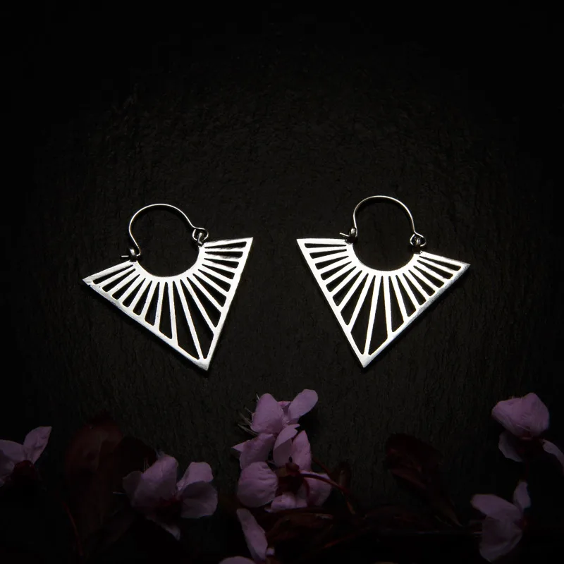 KIWA jewellery brand product image of a pair of silver plated earrings called Uma mini version, set on a dark granite background with dark pink coloured flower decoration on the lower end.