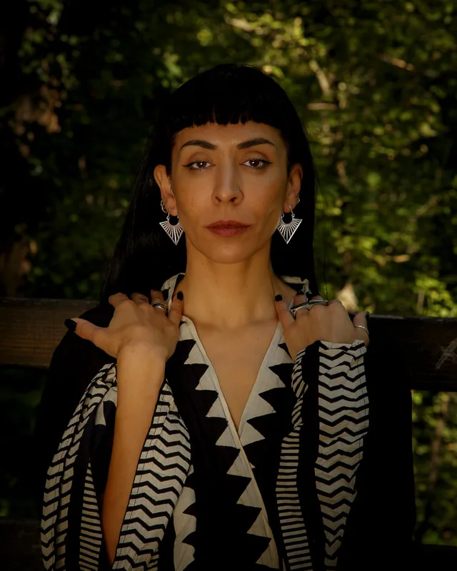 Photo of a Female model wearing Uma Mini Earrings Silver Plated from Kiwa jewellery in a ethnic style kimono in a forest